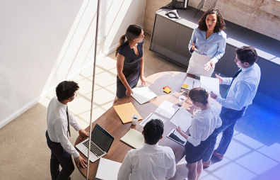 People standing around a desk 1